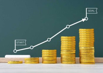 A series of increasing stacks of gold coins are placed from left to right, representing growth. A white line graph with markers runs above the stacks, starting at "Start" and moving upwards to "Goal," symbolizing financial growth through mutual funds over time. | LESSINVEST