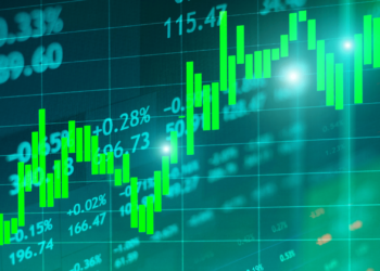 A digital display shows a dynamic stock market chart with green candlesticks indicating increasing values, surrounded by various numerical data and percentages. The background is a grid with a bluish-green tint, subtly prompting the question: How old do you have to be to invest in stocks? | LESSINVEST