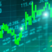 A digital display shows a dynamic stock market chart with green candlesticks indicating increasing values, surrounded by various numerical data and percentages. The background is a grid with a bluish-green tint, subtly prompting the question: How old do you have to be to invest in stocks? | LESSINVEST