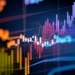 A colorful display of various financial graphs and charts with multiple lines, bars, and numerical indicators. The image illustrates data trends, fluctuations, and market analysis with vibrant hues against a dark background, symbolizing passive income activities. | LESSINVEST
