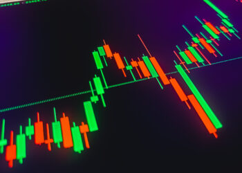 A dark screen displays a candlestick chart with green and red bars, highlighting potential turning points in financial markets. The chart shows fluctuating prices over time, indicating possible trends in financial trading or stock market analysis. | LESSINVEST