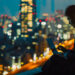 A man in a suit works on a laptop by a window at night, with a city skyline full of illuminated buildings and blurred lights in the background. | LESSINVEST