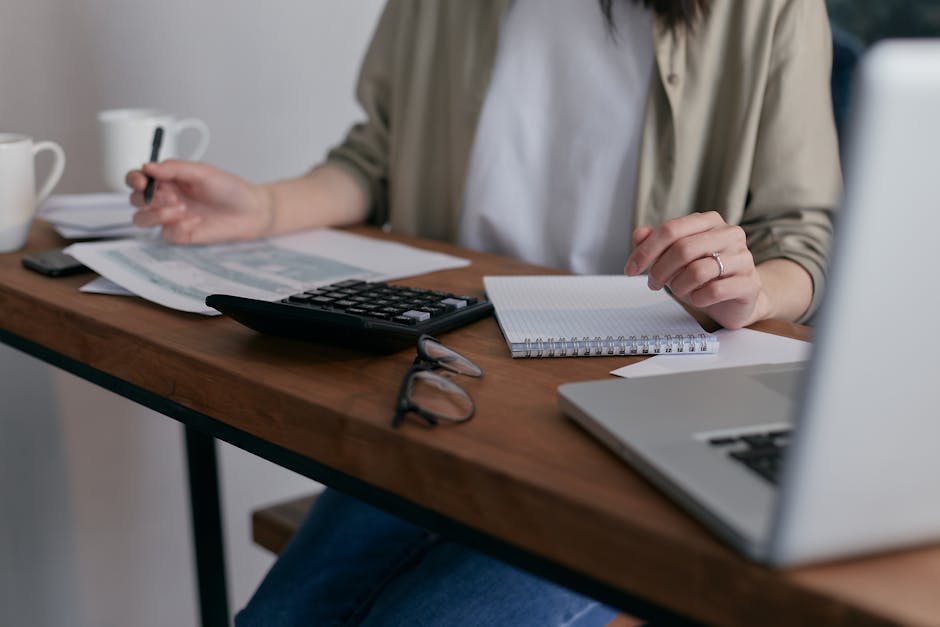 Person reviewing tax documents and calculator for EV incentives