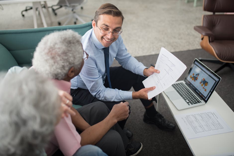 Financial advisor discussing documents with senior clients in an office setting, showcasing a collaborative consulting session